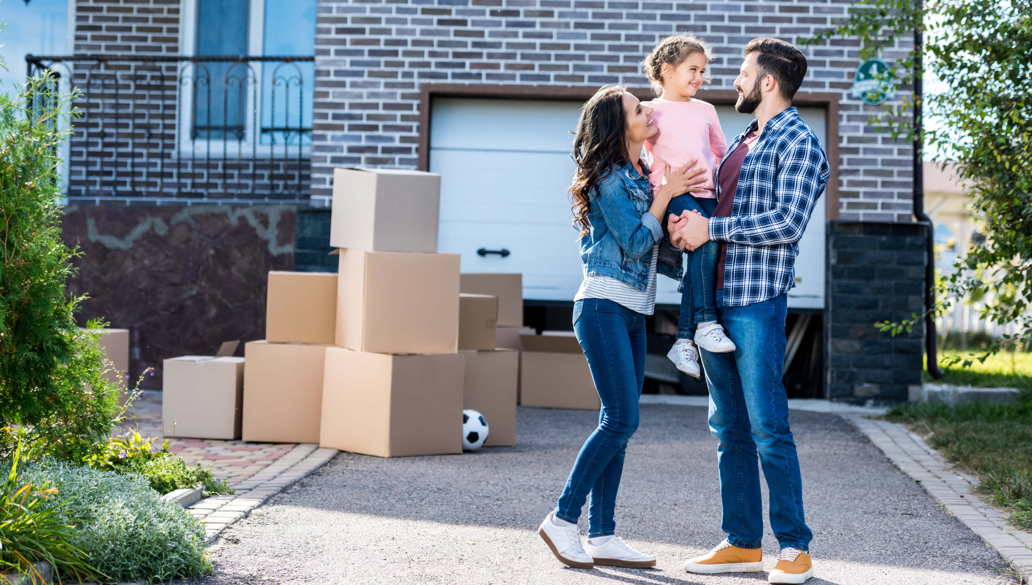 Happy family outside their new house on moving day