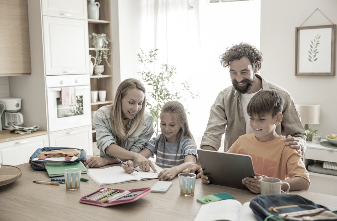 Happy family with keys in new home